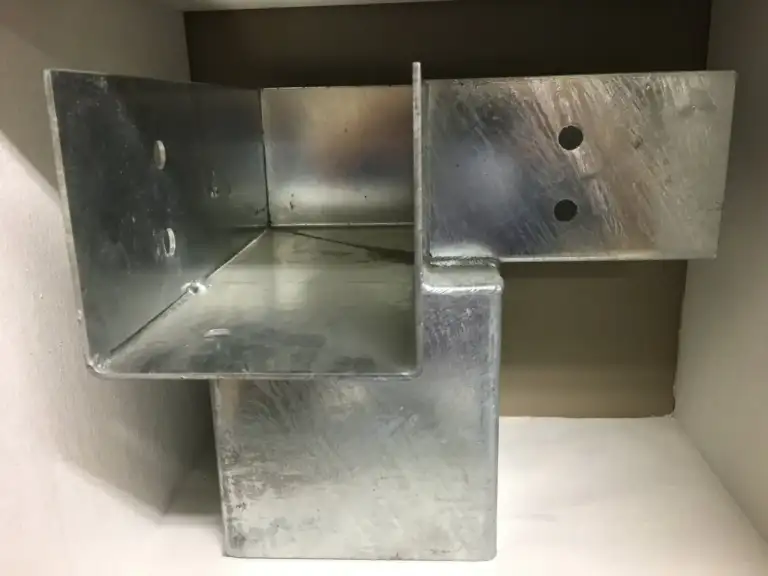 Close-up of a galvanized Ty-Rite anchor bracket showing the post saddle and bolt holes