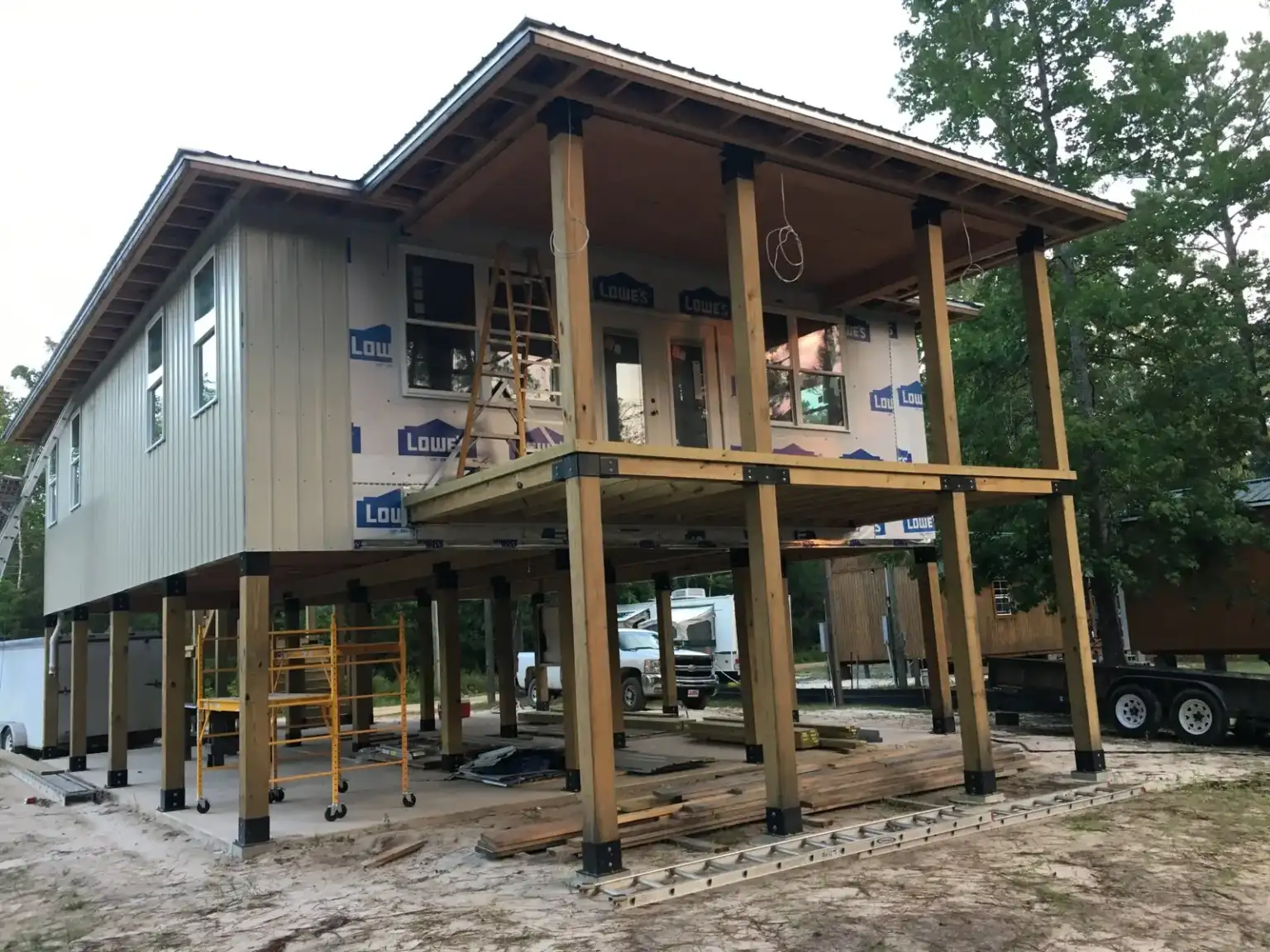 Two-story elevated home under construction, its wood posts standing on Ty-Rite anchors