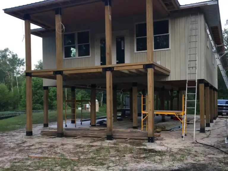 Elevated home on Ty-Rite anchored wood posts with a covered porch