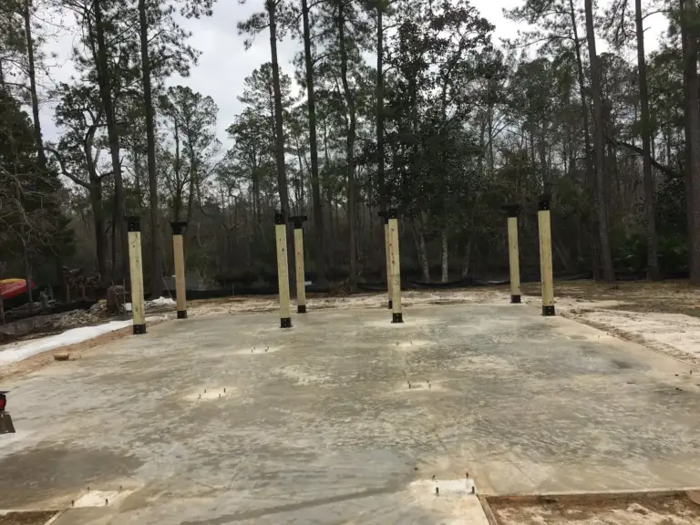 Wood posts standing on Ty-Rite anchors above a finished concrete slab
